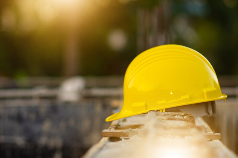 Hard hat helmet safety on site construction background